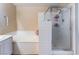 Bright bathroom features a shower with glass door, soaking tub with white tile, and neutral walls at 3950 S Sandhill Rd # 130, Las Vegas, NV 89121