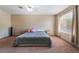 Spacious bedroom with a large window, carpeted floors, and neutral wall colors at 3950 S Sandhill Rd # 130, Las Vegas, NV 89121
