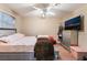 Cozy bedroom featuring neutral walls, a ceiling fan, and comfortable furnishings at 3950 S Sandhill Rd # 130, Las Vegas, NV 89121