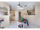 Bright dining area connected to the kitchen, featuring tile floors and a modern chandelier at 3950 S Sandhill Rd # 130, Las Vegas, NV 89121