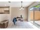 Cozy dining area with sliding glass doors to the patio, featuring tile flooring and a chandelier at 3950 S Sandhill Rd # 130, Las Vegas, NV 89121
