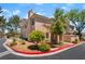 Exterior view of a charming townhouse showcasing well-kept landscaping and a peaked roofline at 3950 S Sandhill Rd # 130, Las Vegas, NV 89121