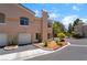 Well-maintained townhouse exterior with a garage, manicured landscaping, and architectural details at 3950 S Sandhill Rd # 130, Las Vegas, NV 89121