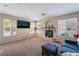 Spacious living room featuring a corner fireplace and large windows with natural light at 3950 S Sandhill Rd # 130, Las Vegas, NV 89121