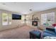 Spacious living room featuring a corner fireplace and large windows with natural light at 3950 S Sandhill Rd # 130, Las Vegas, NV 89121