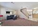 Open living room with carpet floors, neutral walls and a large mirror at 3950 S Sandhill Rd # 130, Las Vegas, NV 89121