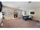 Inviting living room featuring a cozy fireplace, large windows, and a comfortable sofa at 3950 S Sandhill Rd # 130, Las Vegas, NV 89121