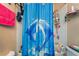 Shower in the bathroom featuring white tile and dolphin-themed curtain at 3950 S Sandhill Rd # 130, Las Vegas, NV 89121