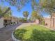 Spacious backyard with lush lawn, mature trees, providing a private and serene outdoor space at 401 Obsidian St, Las Vegas, NV 89145