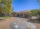 Expansive backyard featuring mature trees, desert landscaping and a paved stone pathway at 401 Obsidian St, Las Vegas, NV 89145