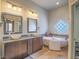 Elegant bathroom featuring double vessel sinks, jetted tub, and stylish tile accents at 401 Obsidian St, Las Vegas, NV 89145