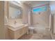 Clean and modern bathroom featuring a vanity with sleek sink, toilet and shower tub combination at 401 Obsidian St, Las Vegas, NV 89145