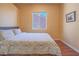 Comfortable bedroom with window view, neutral tones, and hardwood style flooring at 401 Obsidian St, Las Vegas, NV 89145