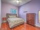 Cozy bedroom with gray walls, wooden dresser, and hardwood floors at 401 Obsidian St, Las Vegas, NV 89145