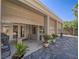 Large covered patio with roll down shades and views of flagstone and lush backyard landscaping at 401 Obsidian St, Las Vegas, NV 89145