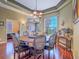 Formal dining room boasts modern lighting, round table, and hardwood floors with view to the Living Room at 401 Obsidian St, Las Vegas, NV 89145