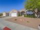 Well-maintained single-story home with desert landscaping, three car garage and inviting curb appeal at 401 Obsidian St, Las Vegas, NV 89145