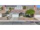 Charming home featuring a well-manicured front yard, complemented by a spacious two-car garage and neutral paint at 401 Obsidian St, Las Vegas, NV 89145