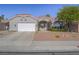 Charming single-story home featuring a red tile roof, landscaped front yard and a two car garage at 401 Obsidian St, Las Vegas, NV 89145