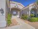 Beautiful house featuring a red tiled roof, arched entry way, and desert landscaping at 401 Obsidian St, Las Vegas, NV 89145