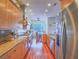 Stylish kitchen with stainless steel appliances, hardwood floors, and open layout to the dining area at 401 Obsidian St, Las Vegas, NV 89145