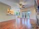 Open-concept living room featuring wood floors, ceiling fan, and access to the backyard at 401 Obsidian St, Las Vegas, NV 89145