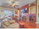 Cozy living room offers fireplace, hardwood floors, ceiling fan, and convenient access to the backyard at 401 Obsidian St, Las Vegas, NV 89145