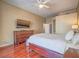Bright main bedroom featuring a ceiling fan, wooden dresser, and rich hardwood flooring at 401 Obsidian St, Las Vegas, NV 89145