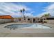 View of the expansive backyard featuring an empty in-ground swimming pool and two palm trees at 4067 E Colorado Ave, Las Vegas, NV 89104