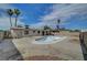 Wide backyard with an empty pool, palm trees, and a block wall at 4067 E Colorado Ave, Las Vegas, NV 89104