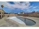The backyard of the house has an empty in-ground swimming pool and a palm tree at 4067 E Colorado Ave, Las Vegas, NV 89104
