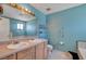 Bathroom featuring double sinks, blue walls, toilet, and bath at 4067 E Colorado Ave, Las Vegas, NV 89104