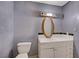 A simple bathroom with a vanity and toilet; the walls are textured and painted gray at 4067 E Colorado Ave, Las Vegas, NV 89104