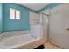 Bathroom showcases a soaking tub with showerhead, a window, and tile flooring at 4067 E Colorado Ave, Las Vegas, NV 89104