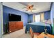 Bedroom with blue walls, tile flooring, ceiling fan, and a window at 4067 E Colorado Ave, Las Vegas, NV 89104