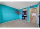 Bedroom features colorful tree mural and access to the hallway and closet at 4067 E Colorado Ave, Las Vegas, NV 89104