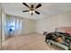 Spacious bedroom with tile floor, ceiling fan, and window provides ample natural light at 4067 E Colorado Ave, Las Vegas, NV 89104