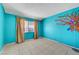 Bright bedroom with vibrant blue walls and a decorative tree accent at 4067 E Colorado Ave, Las Vegas, NV 89104