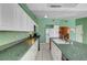 This kitchen features tiled floors, white cabinets, and dark countertops at 4067 E Colorado Ave, Las Vegas, NV 89104