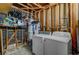 Unfinished laundry room features a washer, dryer, water heater, and exposed wood frame at 4067 E Colorado Ave, Las Vegas, NV 89104