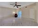 Spacious living room with tile floors, ceiling fan, and a comfortable armchair at 4067 E Colorado Ave, Las Vegas, NV 89104
