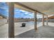 Covered patio with pillars overlooks a large backyard and empty in-ground pool at 4067 E Colorado Ave, Las Vegas, NV 89104