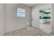 A room featuring a barred window, a pet door, and an open door view of the kitchen at 4067 E Colorado Ave, Las Vegas, NV 89104