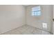 A basic room with tile flooring, a window with bars, and a pet door at 4067 E Colorado Ave, Las Vegas, NV 89104
