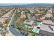 An elevated view showcases the beautiful home, solar panels, refreshing pool, and luscious landscaping at 4196 Balmoral Castle Ct, Las Vegas, NV 89141