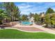 This backyard features a beautiful pool and spa, patio area, and outdoor fireplace for relaxing by the pool at 4196 Balmoral Castle Ct, Las Vegas, NV 89141