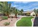 A lovely backyard features palm trees, a pristine pool and spa, and ample outdoor space at 4196 Balmoral Castle Ct, Las Vegas, NV 89141
