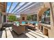 Inviting outdoor living space with covered patio, pergola, and a view of the sparkling pool at 4196 Balmoral Castle Ct, Las Vegas, NV 89141