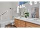 Bathroom featuring double sinks, a vanity, and tub with shower; decorated with flowers at 4196 Balmoral Castle Ct, Las Vegas, NV 89141