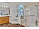Luxurious bathroom features a soaking tub, walk-in shower, and a stylish vanity with double sinks at 4196 Balmoral Castle Ct, Las Vegas, NV 89141